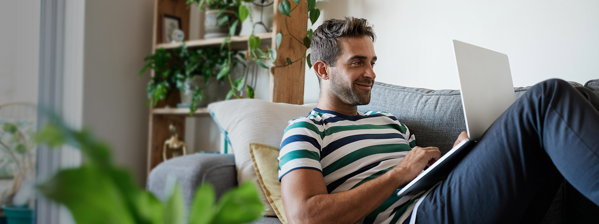 man with computer on couch